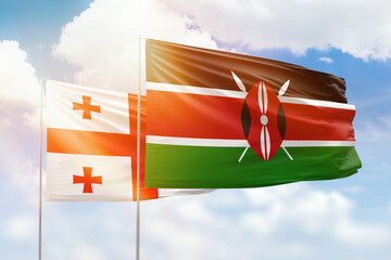 Sunny blue sky and flags of kenya and georgia