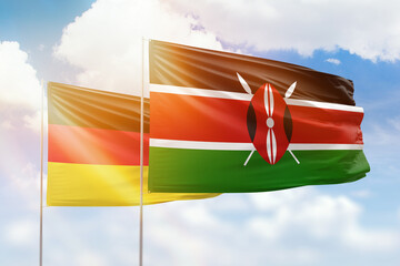 Sunny blue sky and flags of kenya and germany