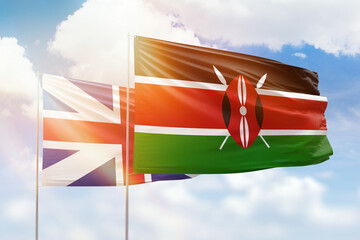 Sunny blue sky and flags of kenya and great britain