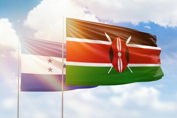 Sunny blue sky and flags of kenya and honduras
