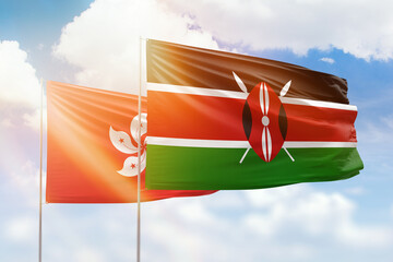 Sunny blue sky and flags of kenya and hong kong