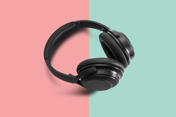 Computer headphones. Black headphones on a white background. The concept of listening to music, creating audio, music. Computer work, abstraction and minimalist style.