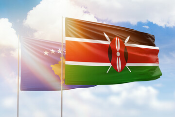 Sunny blue sky and flags of kenya and kosovo