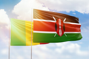Sunny blue sky and flags of kenya and mali