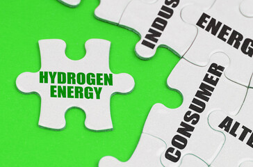 On a green surface are white puzzles with text, on a separate puzzle there is an inscription - hydrogen energy