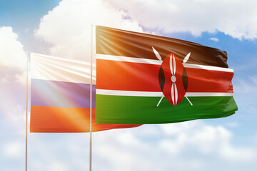 Sunny blue sky and flags of kenya and russia