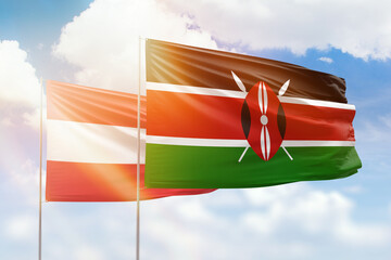 Sunny blue sky and flags of kenya and austria