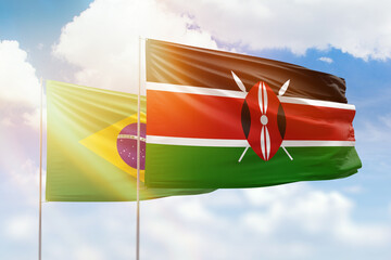 Sunny blue sky and flags of kenya and brazil