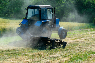 Fototapeta premium Road services landscaping around roads in tractor mows lawn grass with a mechanical mower mowing grass on the side of the asphalt road.A series of pictures.