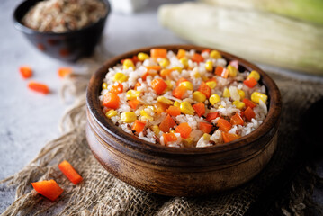 Corn red bell pepper black and white and brown rice in a bowl