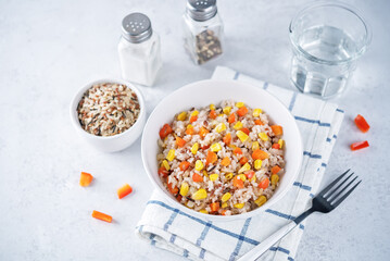Corn red bell pepper black and white and brown rice in a bowl