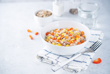 Corn red bell pepper black and white and brown rice in a bowl