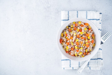 Corn red bell pepper black and white and brown rice in a bowl
