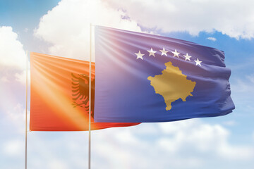 Sunny blue sky and flags of kosovo and albania