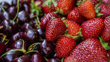 strawberries and cherries on the shelf of a store, market, close-up