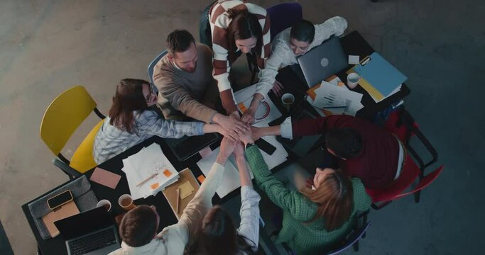 Top view business team join hands, applaud celebrating teamwork success at office work meeting table slow motion.