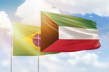 Sunny blue sky and flags of kuwait and brazil
