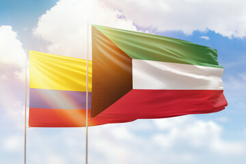 Sunny blue sky and flags of kuwait and colombia