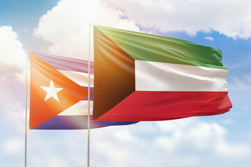 Sunny blue sky and flags of kuwait and cuba