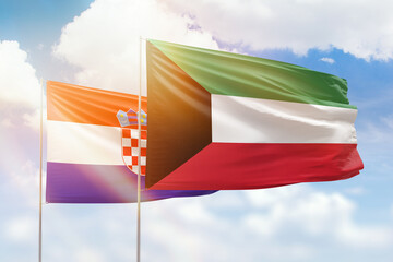 Sunny blue sky and flags of kuwait and croatia