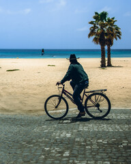 Fototapeta premium person riding a bike on the beach