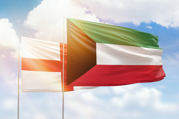 Sunny blue sky and flags of kuwait and england