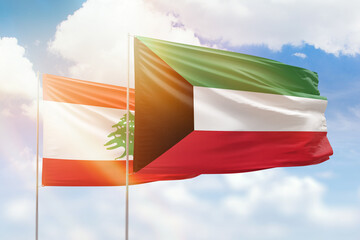 Sunny blue sky and flags of kuwait and lebanon