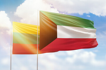 Sunny blue sky and flags of kuwait and lithuania