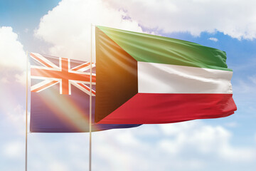 Sunny blue sky and flags of kuwait and new zealand