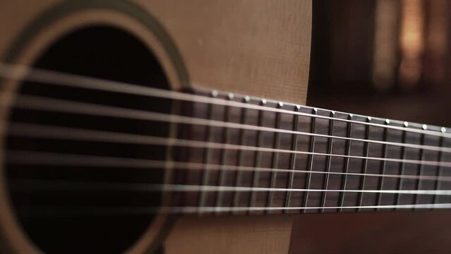 acoustic guitar close up. flying along the strings of a guitar