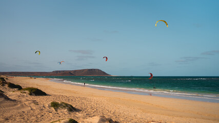 kite surfing on the beach - Powered by Adobe