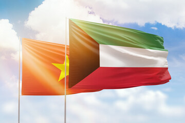 Sunny blue sky and flags of kuwait and vietnam