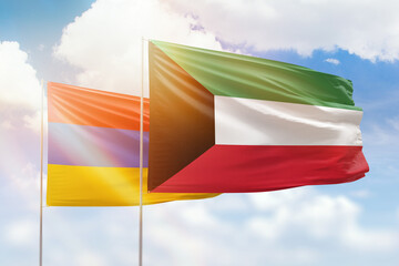 Sunny blue sky and flags of kuwait and armenia