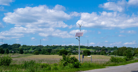 Fototapeta premium renewable energy lighting pole, solar panel and wind turbine