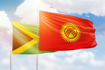 Sunny blue sky and flags of kyrgyzstan and jamaica