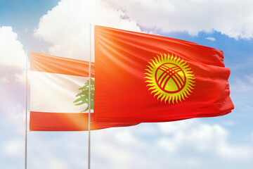 Sunny blue sky and flags of kyrgyzstan and lebanon