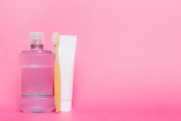 Mouthwash and other oral hygiene products on colored table top view with copy space. Flat lay....