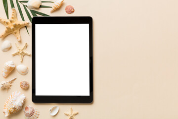 Flat lay composition with tablet and beach accessories on colored background. Tablet computer with...