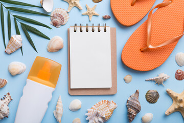 Blank writing book with summer beach accessories on background, copy space. Flat lay with copy space