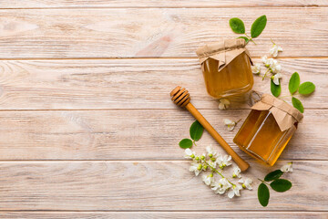 honey jar with acacia flowers and leaves. fresh honey top view flat lay