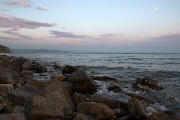 Pink sunset on the Black Sea coast. A late summer evening sinks ashore. Beautiful landscape. Russia.
