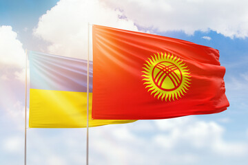 Sunny blue sky and flags of kyrgyzstan and ukraine