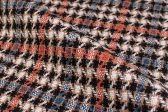 Modern Winter jacket. Black and Brown Glenurquhart check is made of woolen fabric. Herringbone tweed, Wool Background Texture. Coat close-up. Expensive men's suit. High resolution
