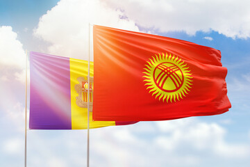 Sunny blue sky and flags of kyrgyzstan and andorra