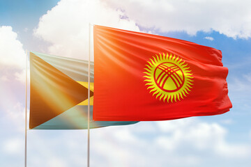 Sunny blue sky and flags of kyrgyzstan and bahamas