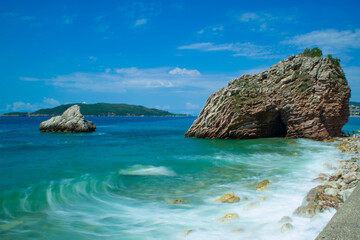 Beautiful rocks on pebble public stone beach. Rafailovici esort towns. Mountenegro. Adriatic Sea.