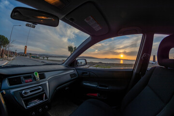 Fototapeta na wymiar driving on the sunset