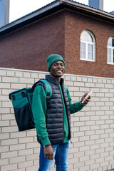 Portrait of a young black man talking on the phone.