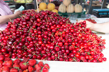 Red ripe fresh cherries on farmers market stall.Close up