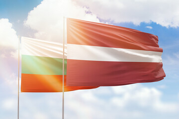 Sunny blue sky and flags of latvia and bulgaria